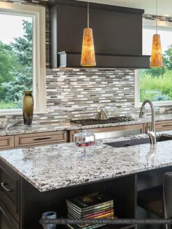 Glass Metal Backsplash Gray Granite Countertop Brown Cabinets