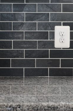 new caledonia granite countertop with black slate subway backsplash tile BA1070