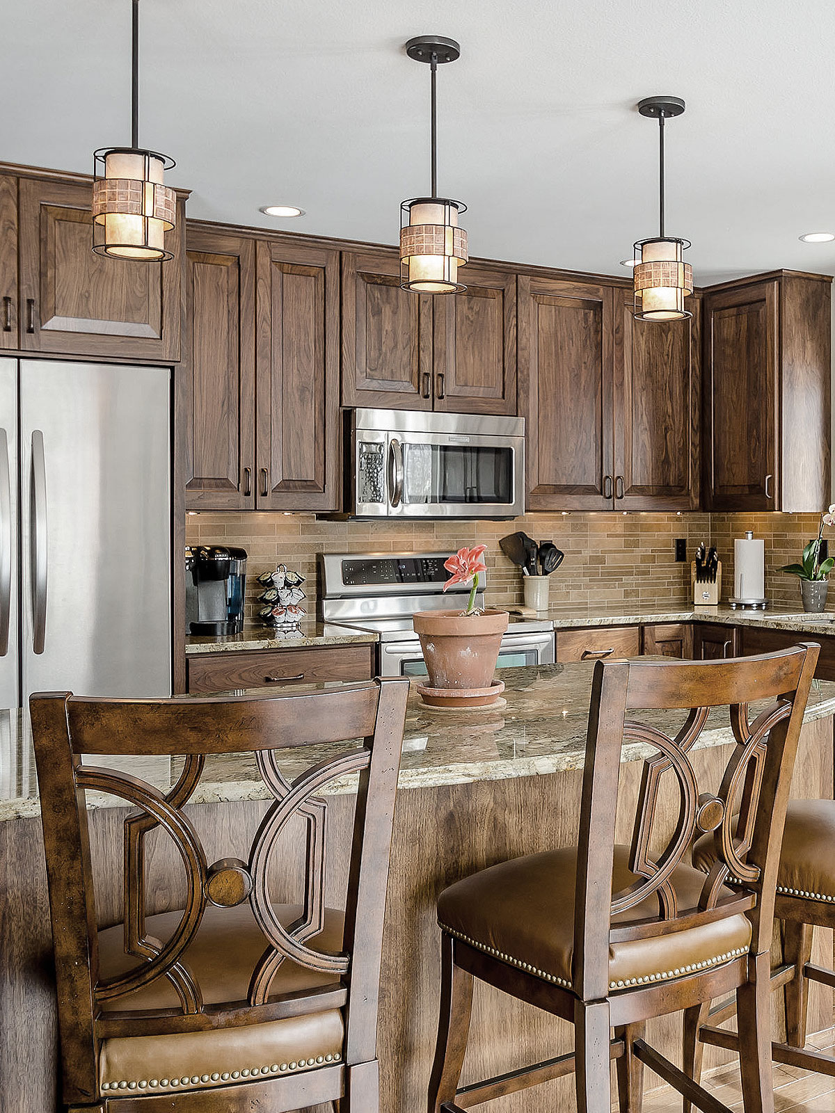 Brown cabinet granite countertop travertine backsplash tile