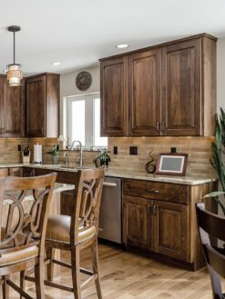 travertine backsplash tile brown cabinets floor granite countertop
