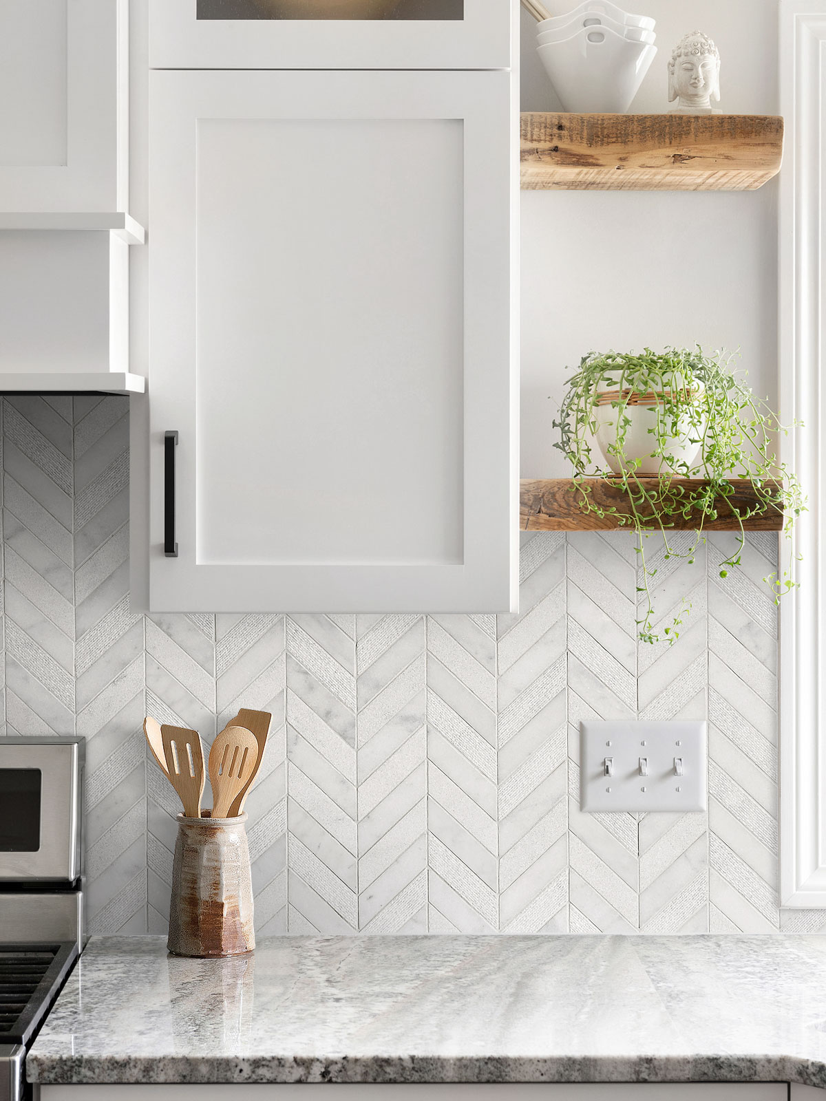 gray granite countertop with cabinets and white marble chevron backsplash tile BA631613