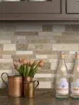 black countertop travertine brown backsplash tile brown cabinets