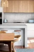 Contemporary Brown Kitchen With Gray Limestone Kitchen Backsplash