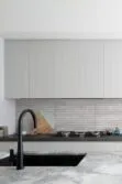 Contemporary Kitchen With Gray Backsplash Tile