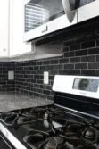 gray granite countertop white cabinet black slate mosaic tile BA1070