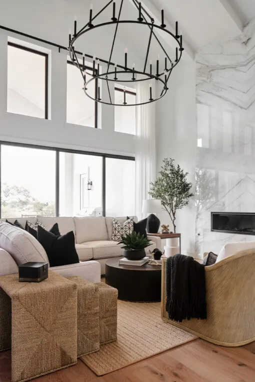 Casual Living Room with Black Castile Chandelier and Bookmatched Tile Fireplace
